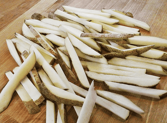 Uncooked French fry wedges